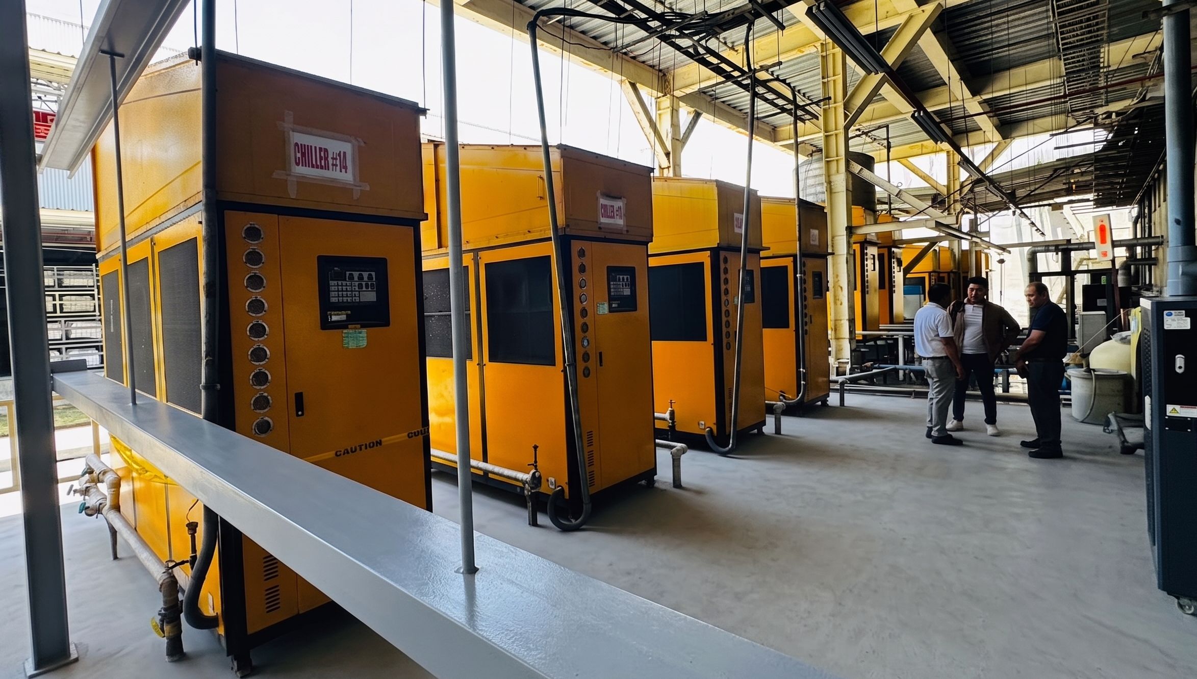 Row of 40RT Air cooling chiller units with top covers installed at an outdoor industrial facility.